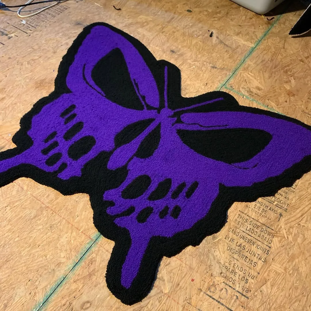 Gothic butterfly skull design rug in purple and black