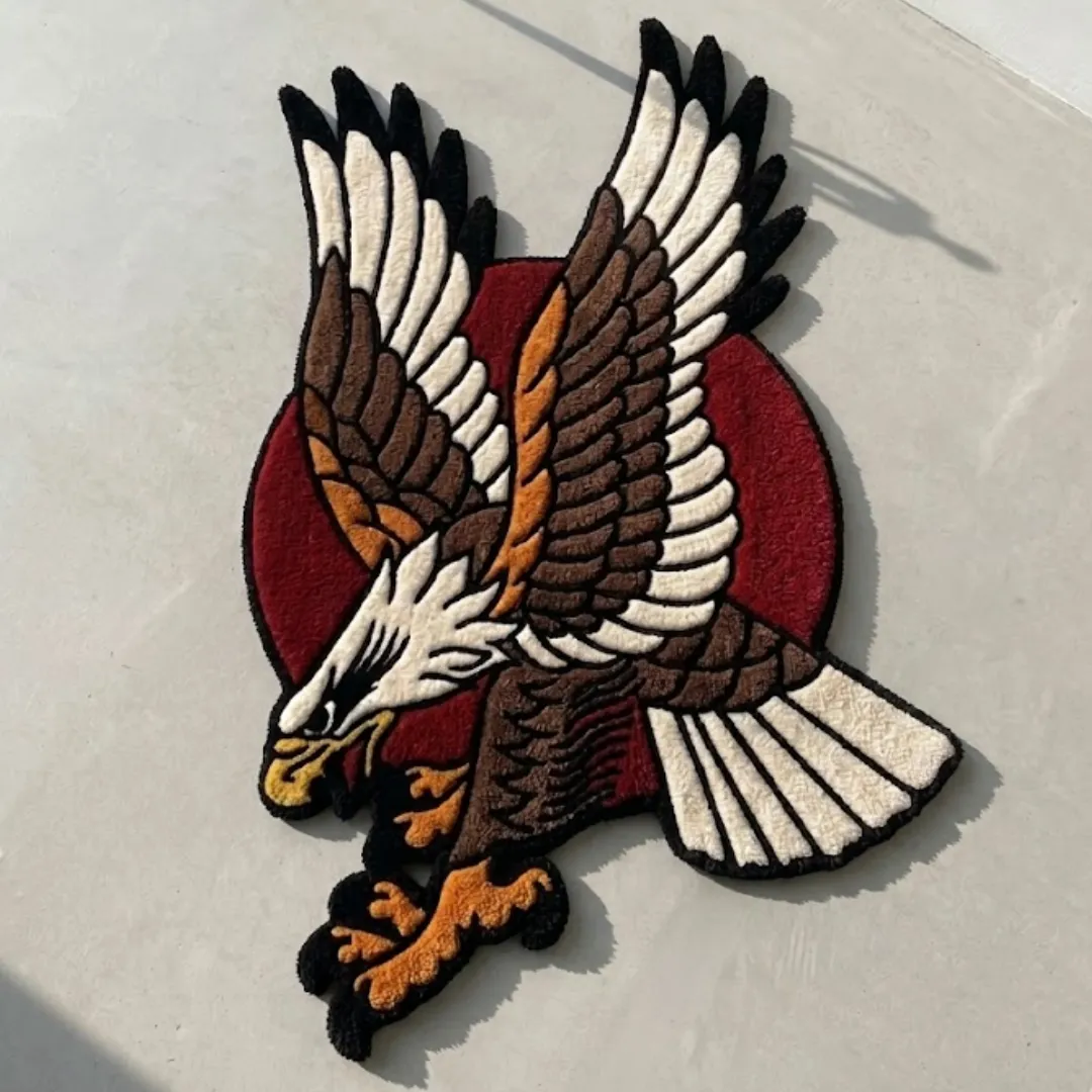 american eagle traditional rug overhead sunlight Overhead view of a tufted American eagle traditional tattoo style rug with spread wings and a red background resting in bright sunlight with cast shadows.