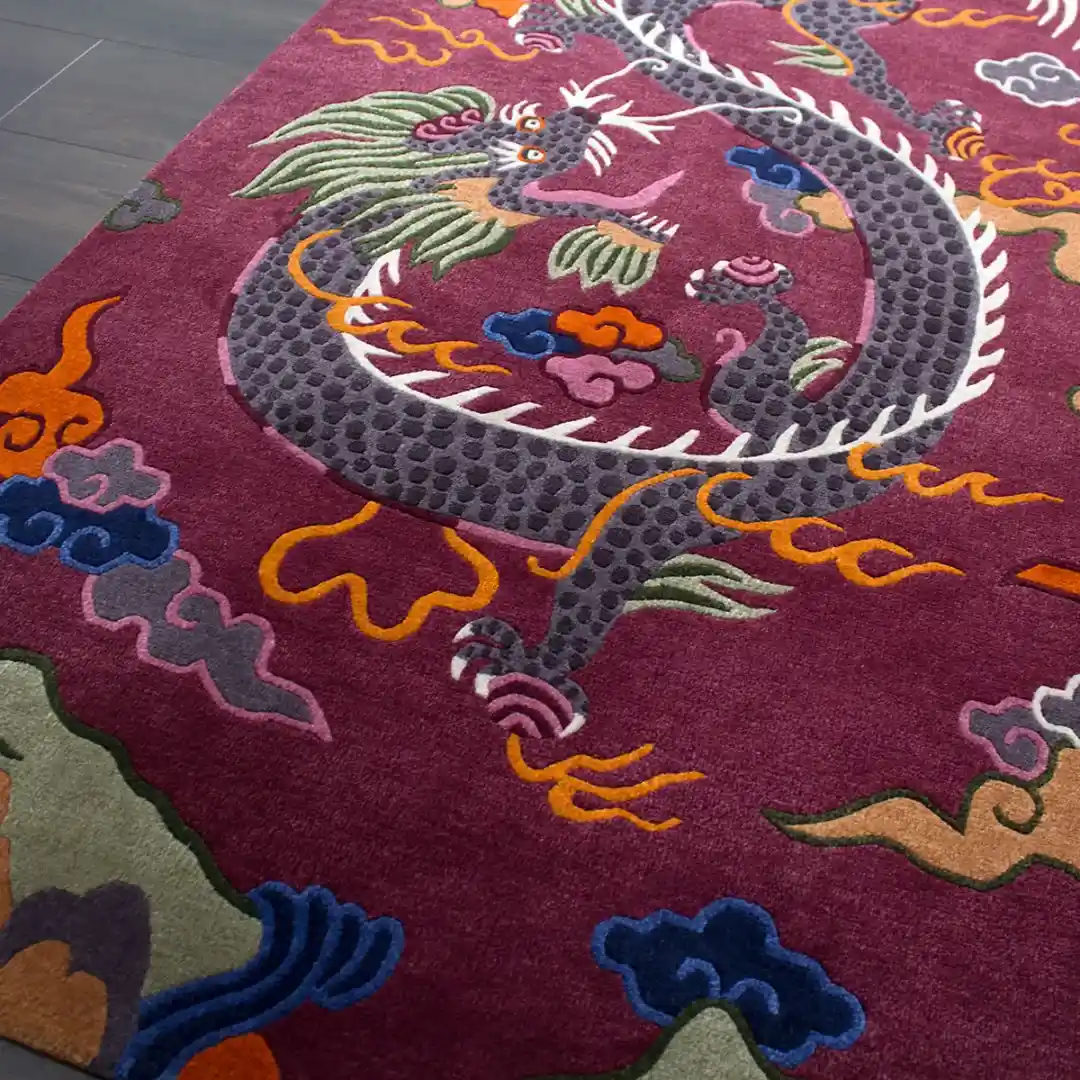 Crimson Omen Rectangular Tibetan Style Rug High angle shot of the Crimson Omen area rug placed on a dark wooden floor, showcasing the bold oriental design and the rich maroon color palette.