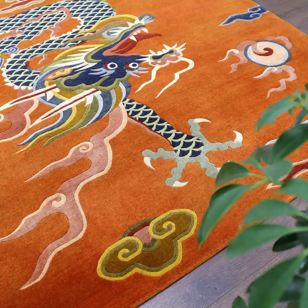 Ember Rise Rug Hand Tufted Wool Detail Close up detail shot of the Ember Rise rug focusing on the hand tufted texture of the dragon's head and scales, showcasing the premium craftsmanship and intricate colors.