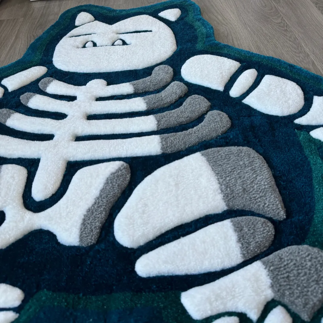 lazy lax rug carved texture detail Angled view of the Lazy Lax rug highlighting the 3D hand-carved details of the rib cage and bones against a plush teal background.