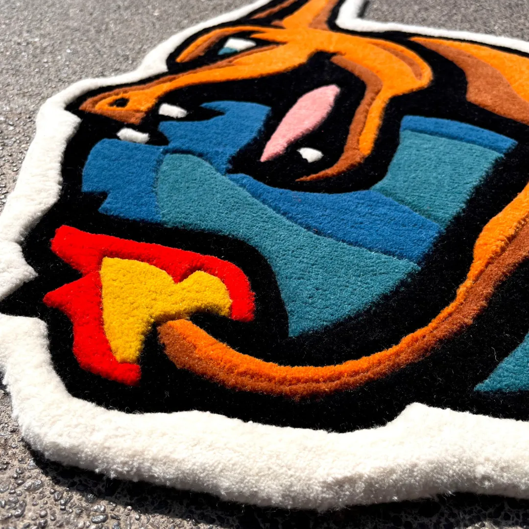 volcanic roar rug wool texture detail Angled view of the Volcanic Roar rug on a tiled floor, showing the unique die-cut shape of a roaring red dragon head with vibrant orange and yellow fire details.