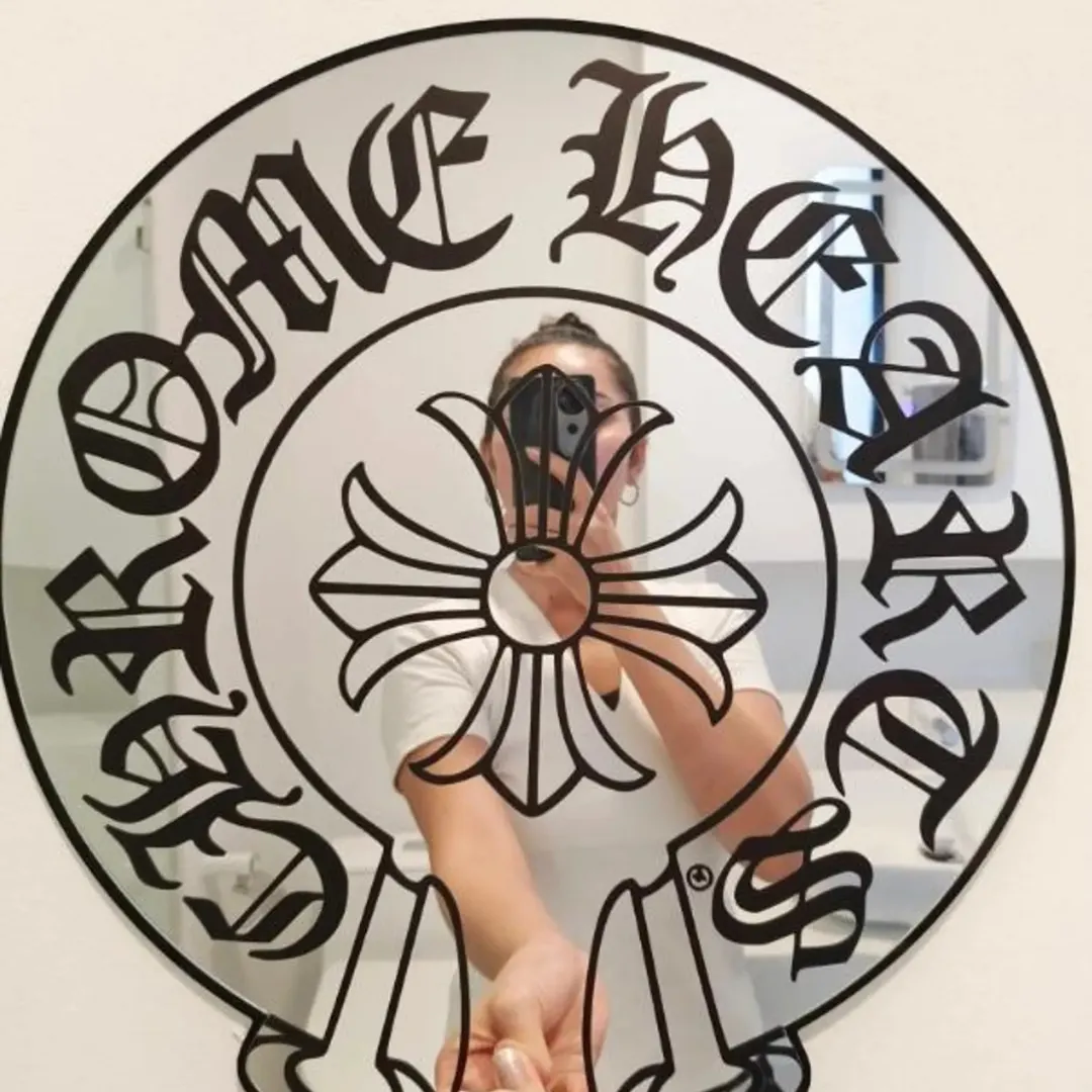 gothic cross acrylic mirror handheld reflection Gothic cross acrylic mirror with black old English lettering held in hand, reflective wall decor design