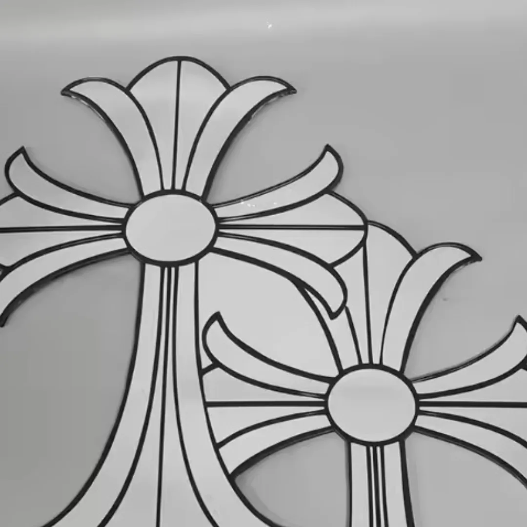 gothic cross mirrors close up detail Close-up, slightly angled view of two gothic cross-shaped mirrors, highlighting the sharp points of the design and the bold black borders against a grey background.