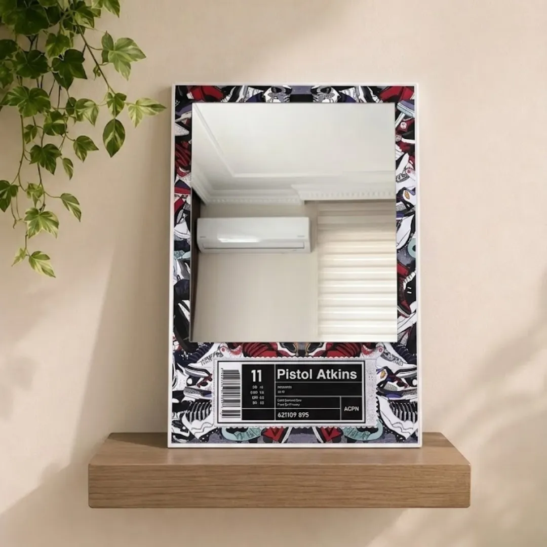 label kicks sneakerhead mirror minimal shelf display A studio shot of the "Pistol Atkins" sneaker-themed mirror displayed on a minimalist light wood floating shelf against a neutral wall with trailing greenery.