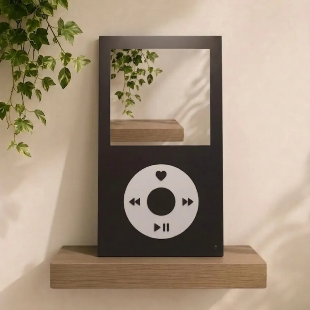 tune frame music player mirror minimalist wall decor Angled view of the Tune Frame mirror, mimicking a retro music player, positioned on a wooden shelf against a wooden wall with hanging ivy foliage.