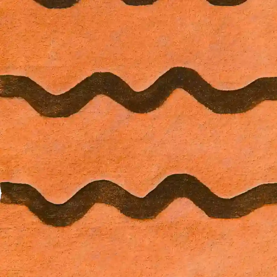 Hand-tufted scallop edge solid orange wool rugs displayed in a modern living room setting.