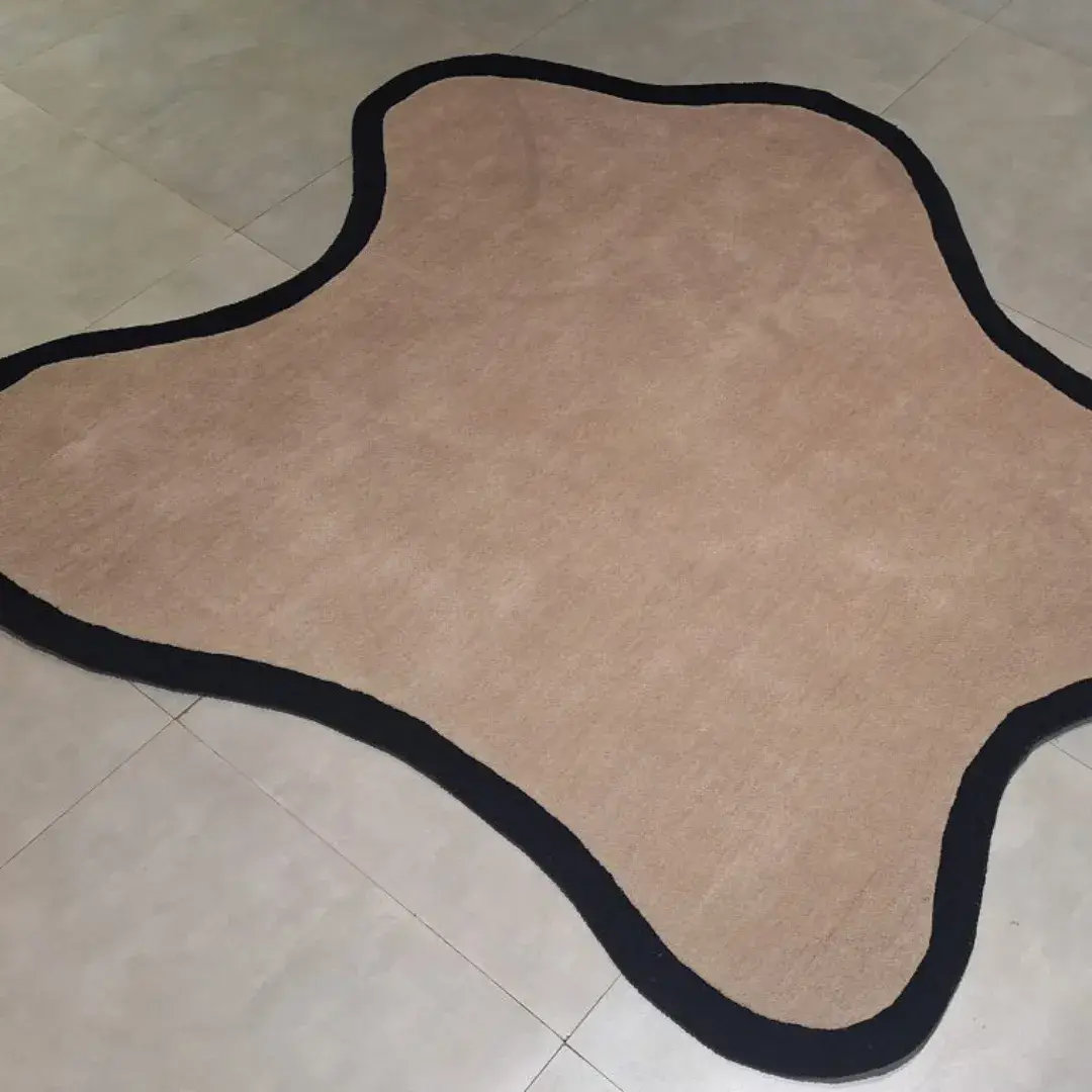 irregular black border hand tufted rug