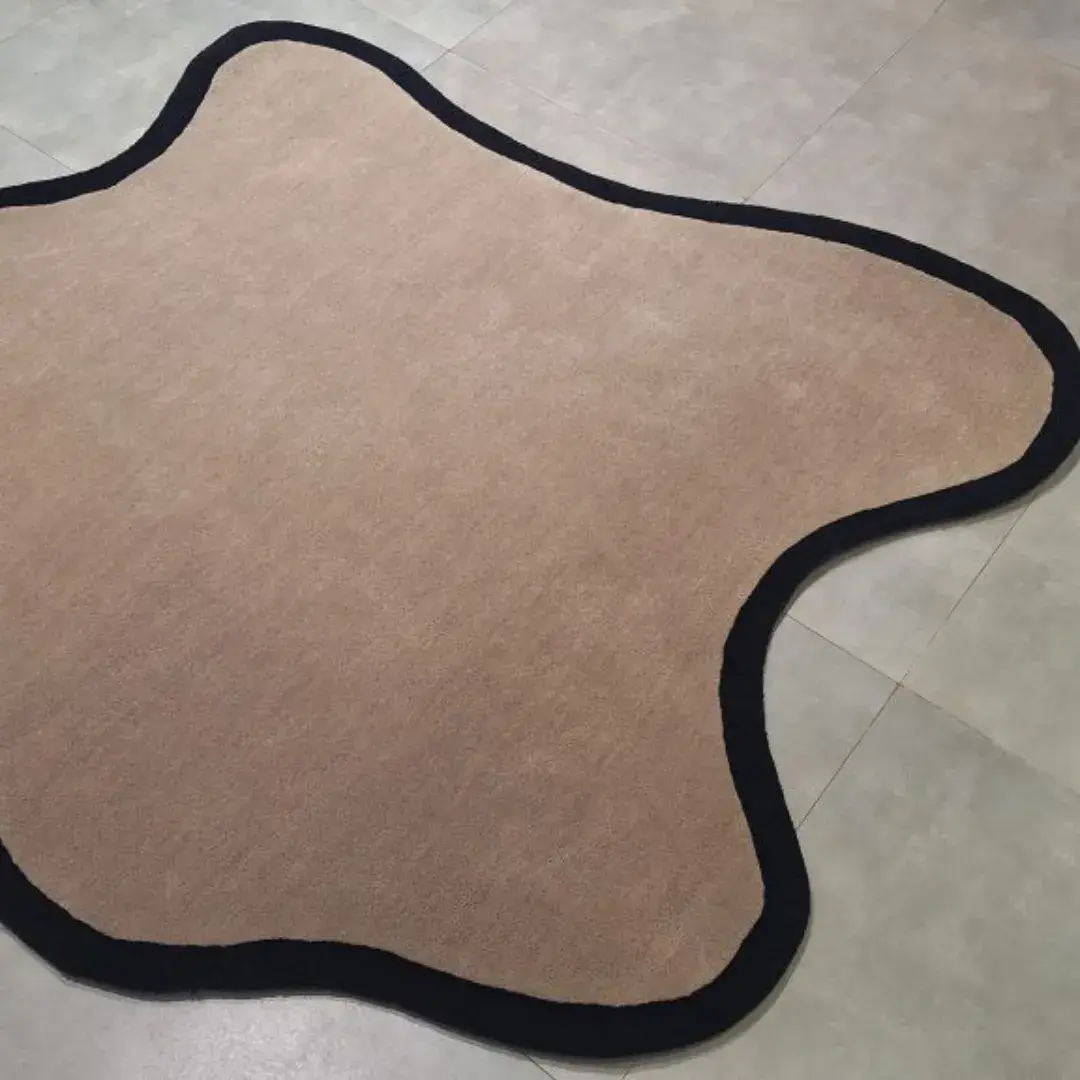 irregular black border hand tufted rug