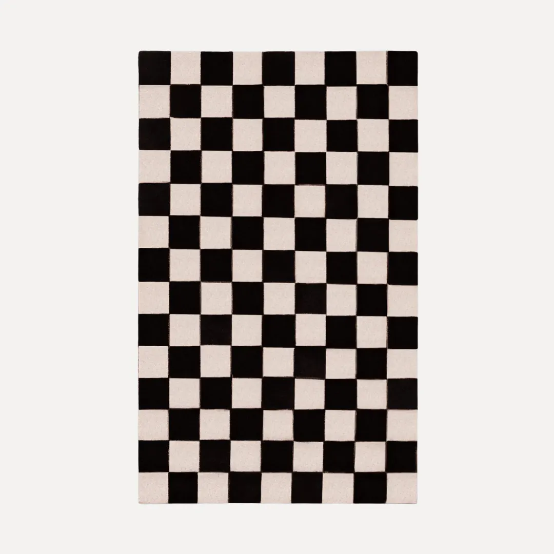 Black and white area rug with checkered pattern in modern room