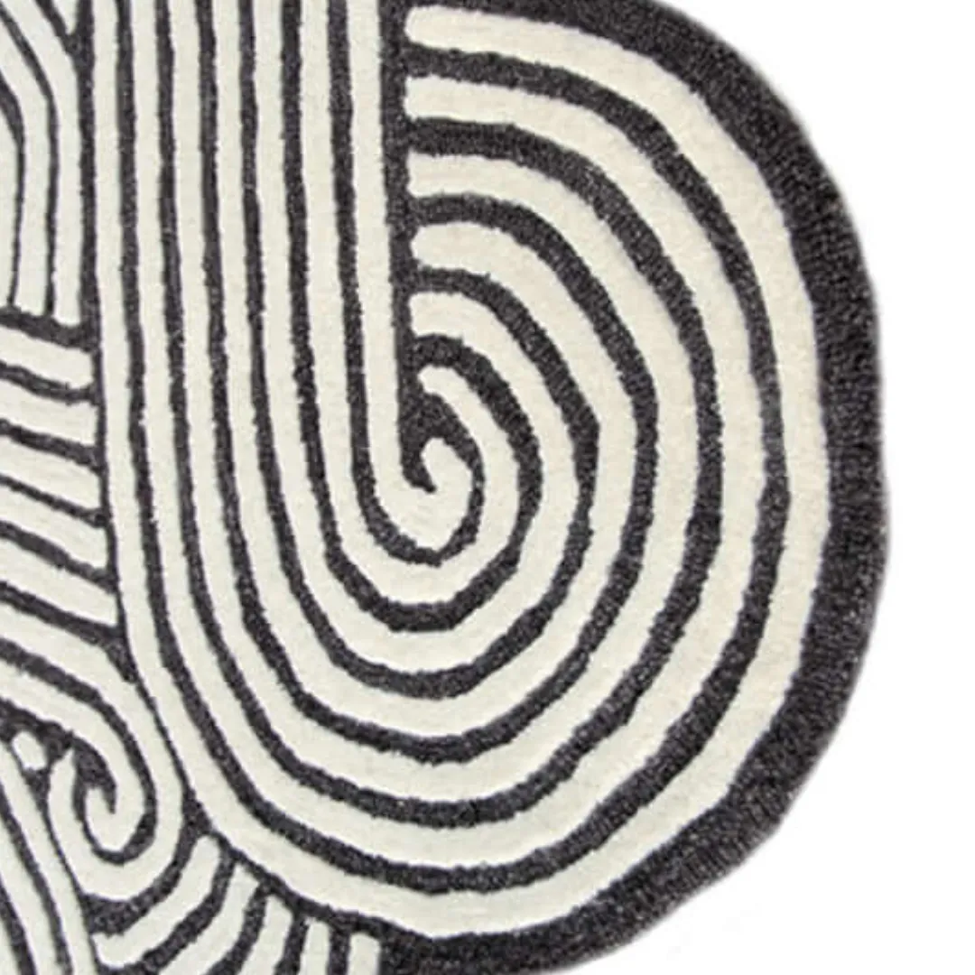 Black and white lines rug styled in a modern creative space