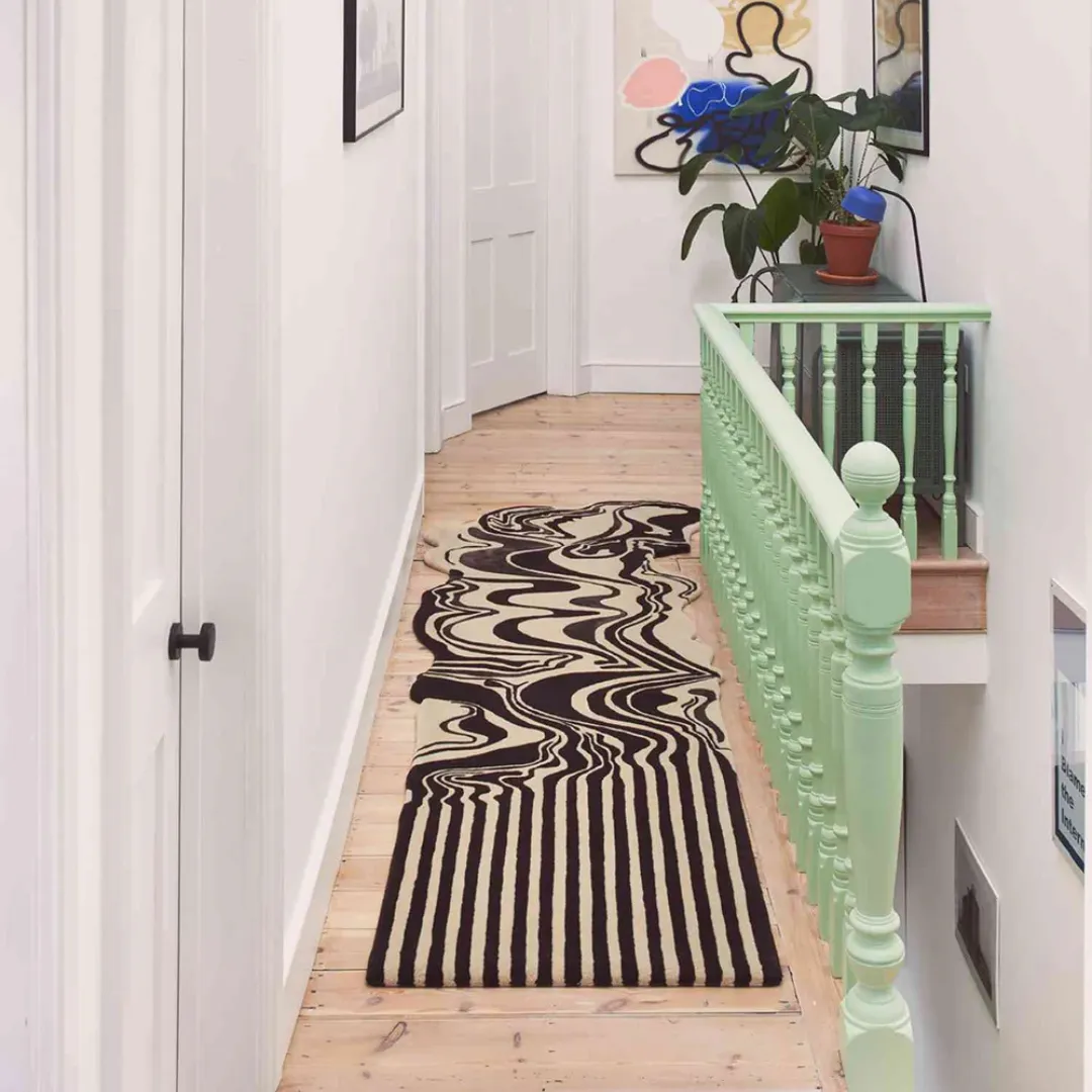Modern hallway with black runner rug featuring artistic waves