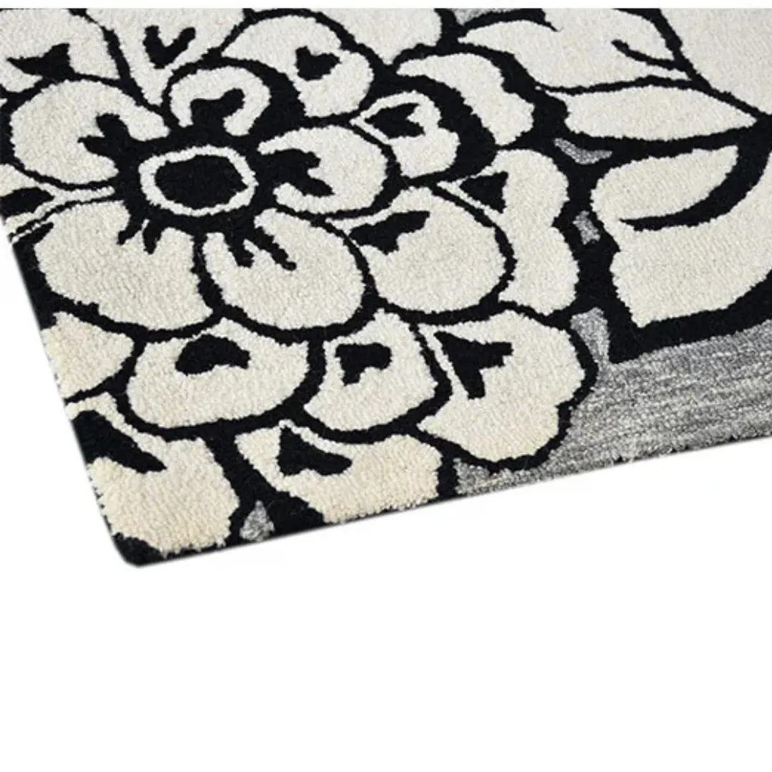 Hand tufted black and white rug featuring large flowers