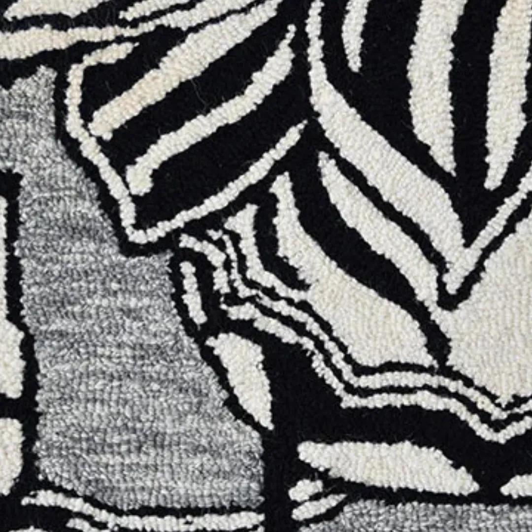 Black floral rug made from New Zealand wool on gray background