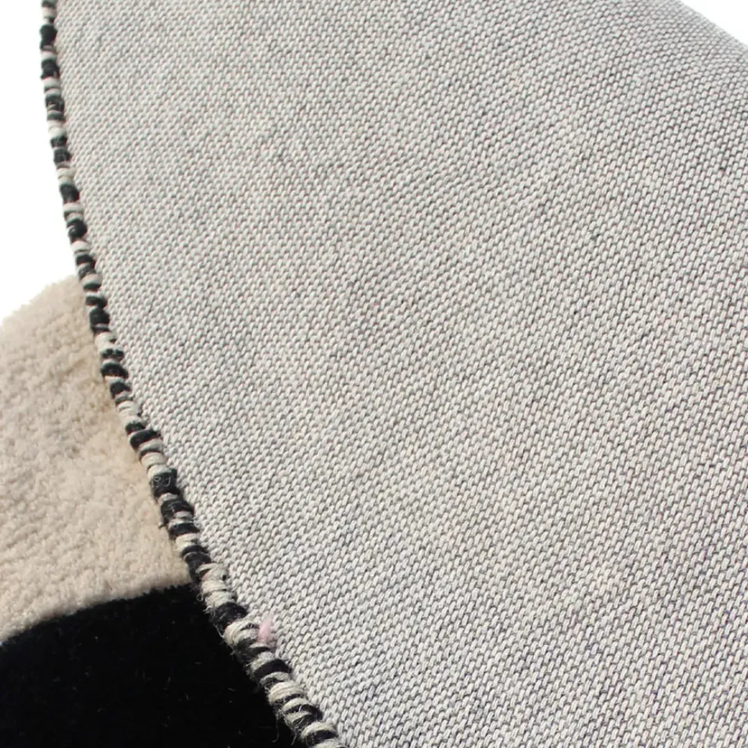 Black circle rug with abstract pattern in a modern room