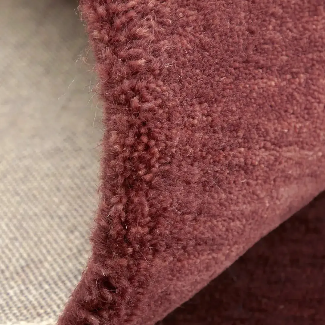 Pixel-style wool rug in warm mocha and pink tones