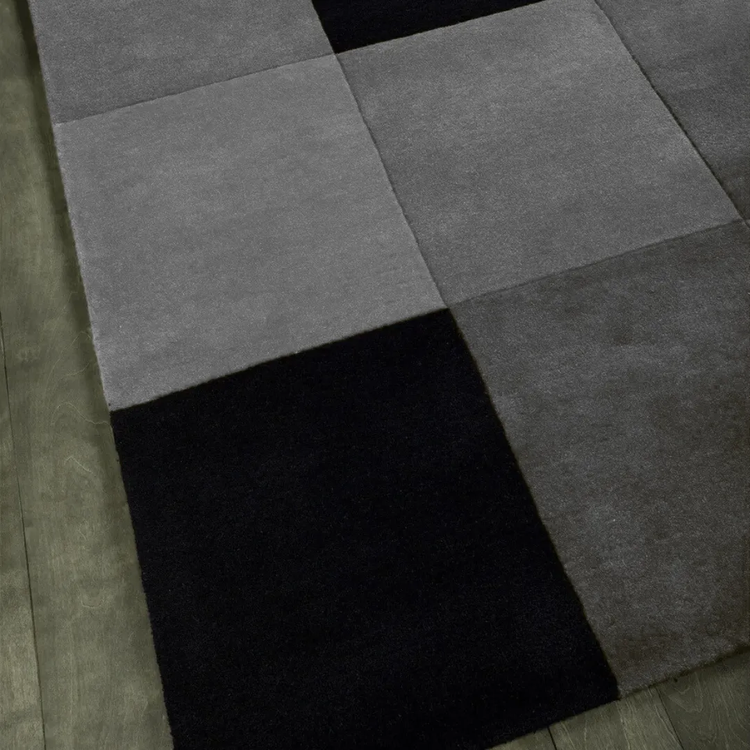 Hand-tufted wool texture in deep gray and soft black