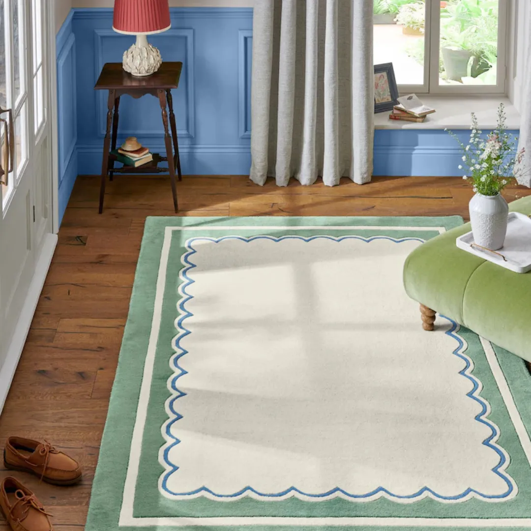 Living room styled with green scallop rug under modern furniture