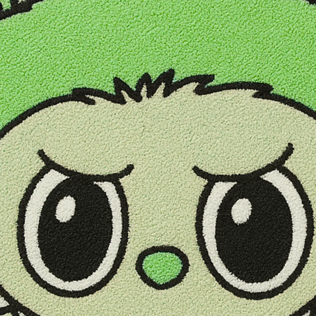 Close-up of tufted wool texture on green Labubu face