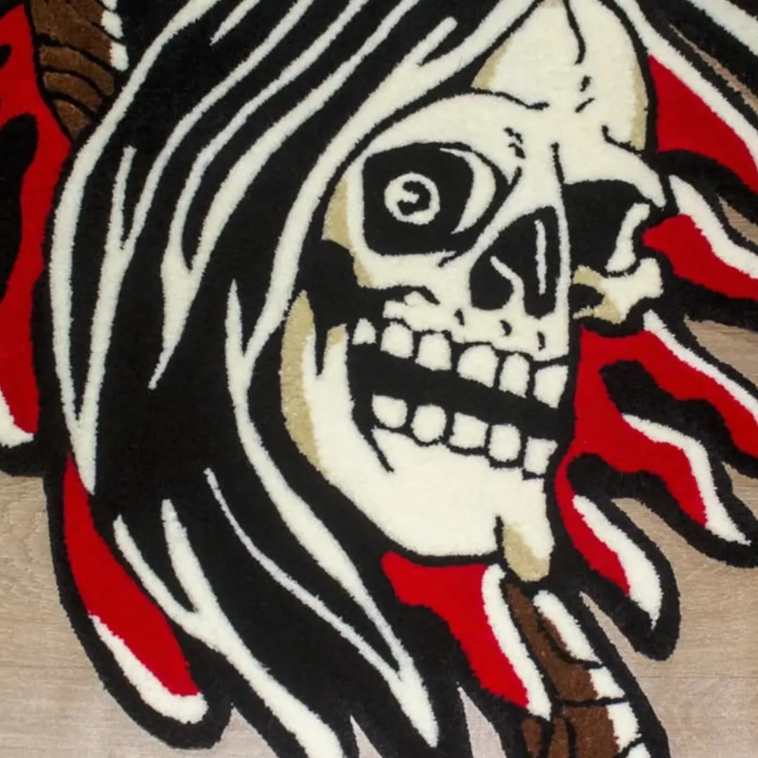 Skull and scythe rug in reaper design, with black hood and red flame-like shapes.