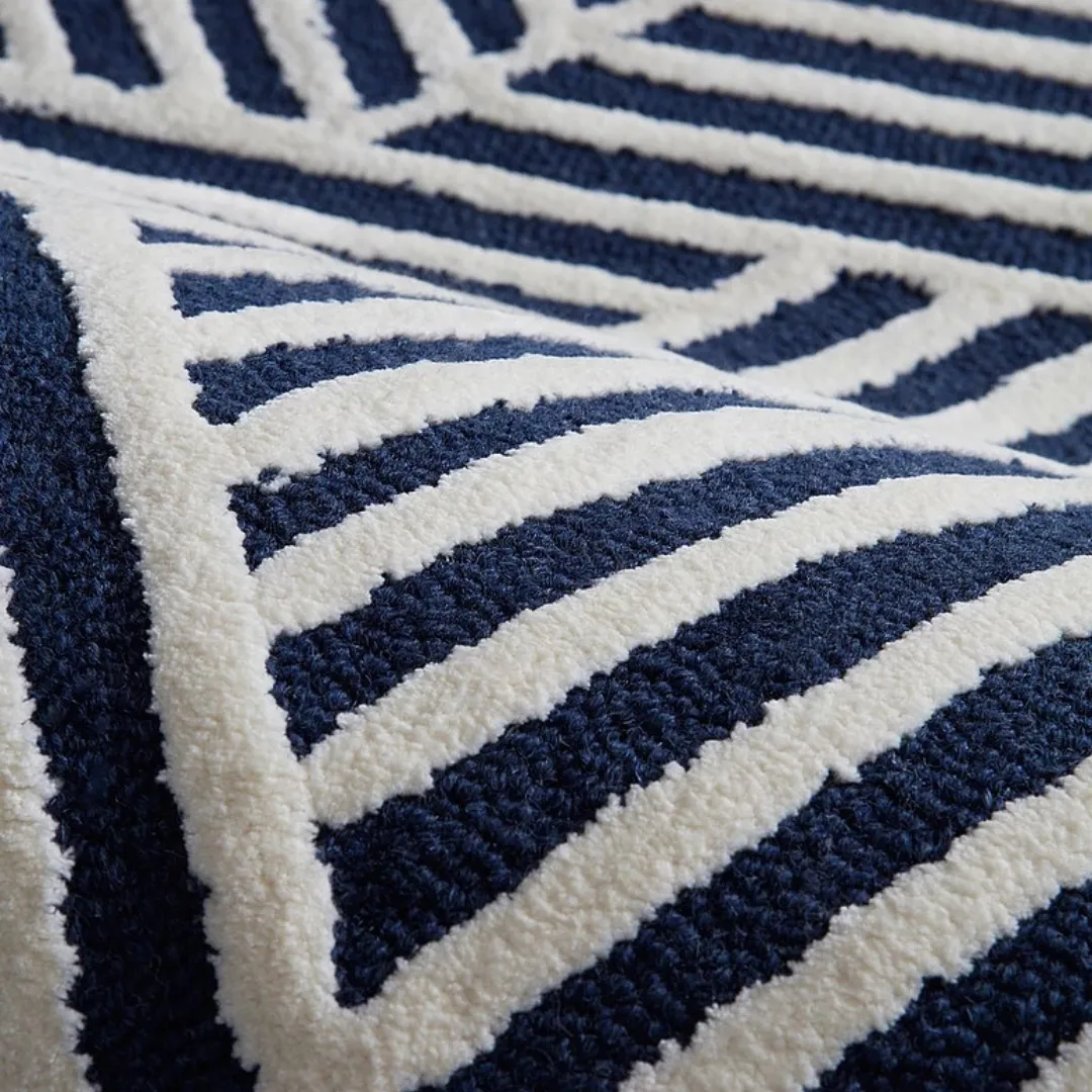 Close-up of hand-tufted wool texture in blue and white stripes