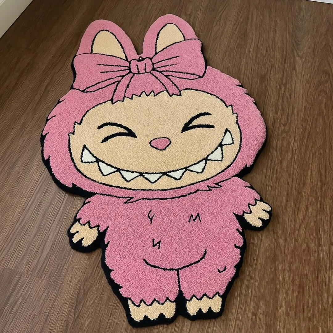 Pink Labubu rug in blush pink with black outline and closed eyes