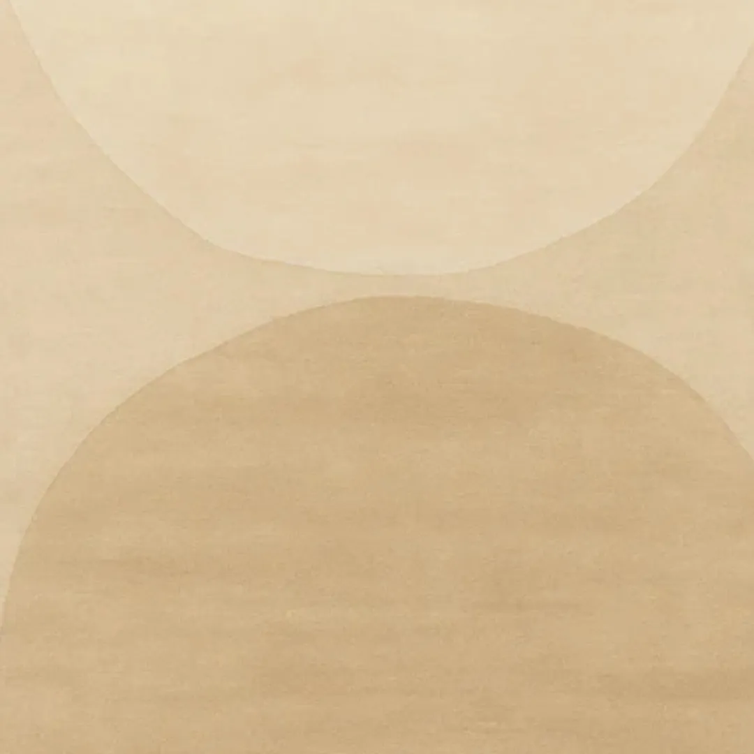 Close-up of hand-tufted beige rug with carved arch details