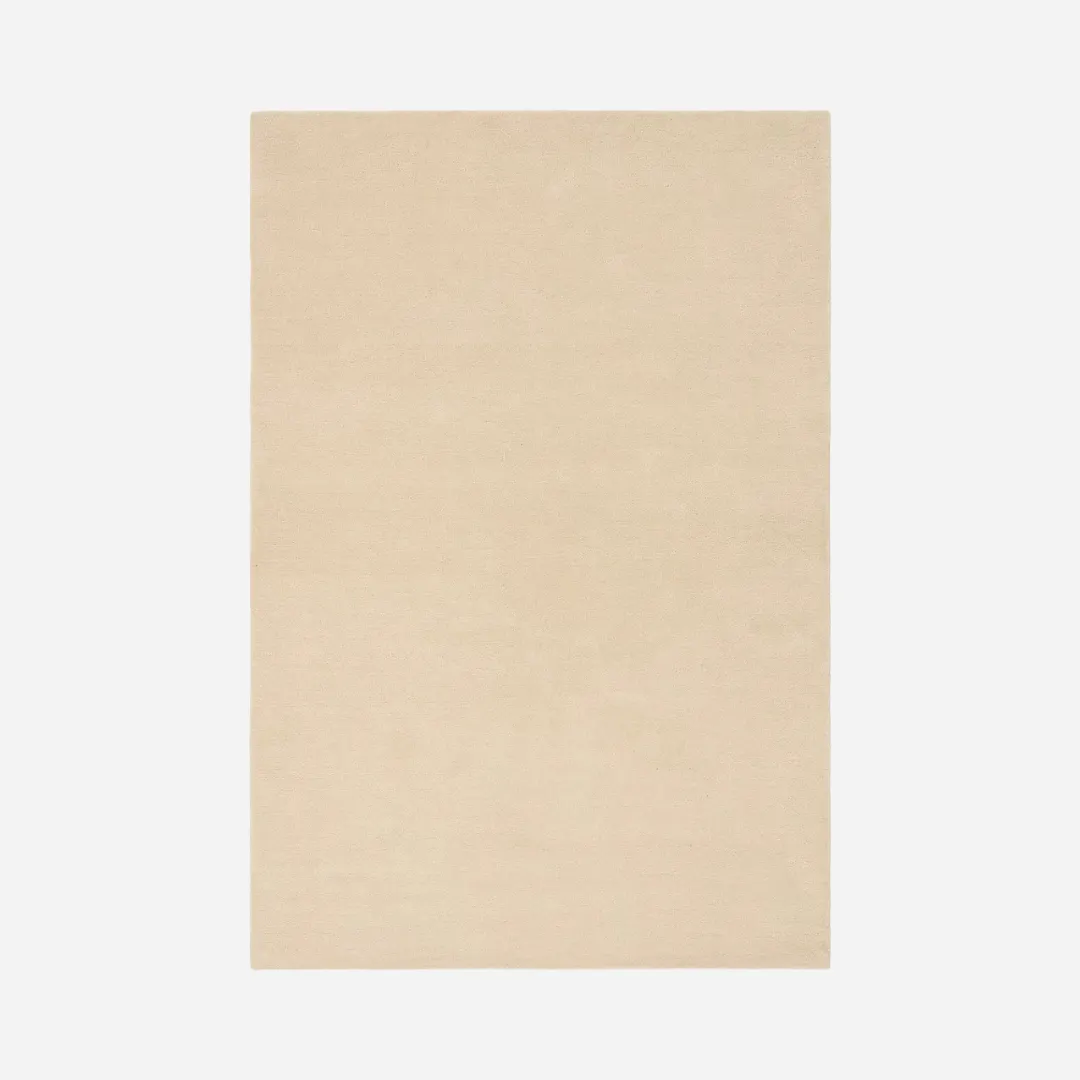 Solid beige area rug with soft ivory tone