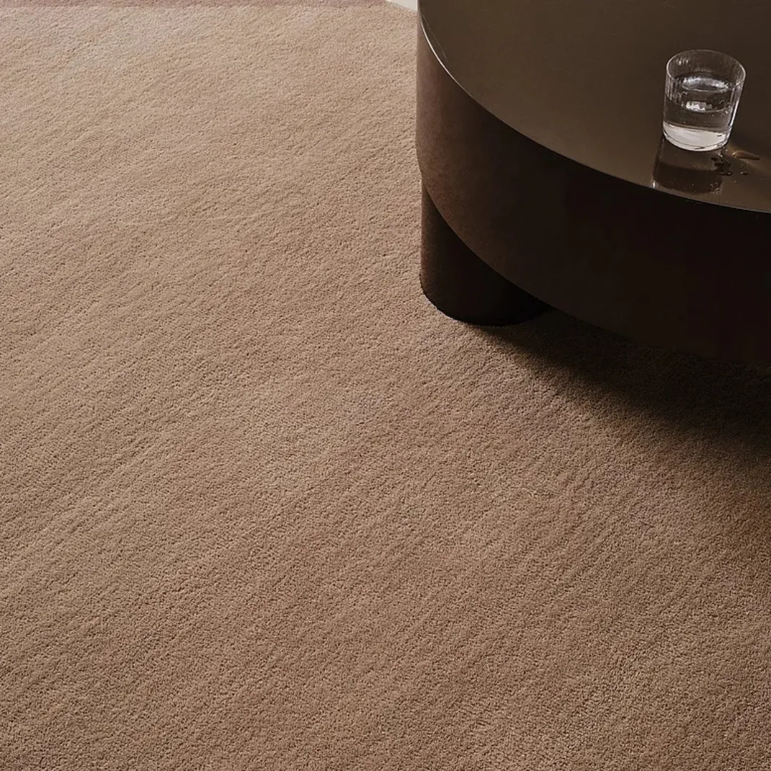 Neutral brown wool rug on hardwood floor