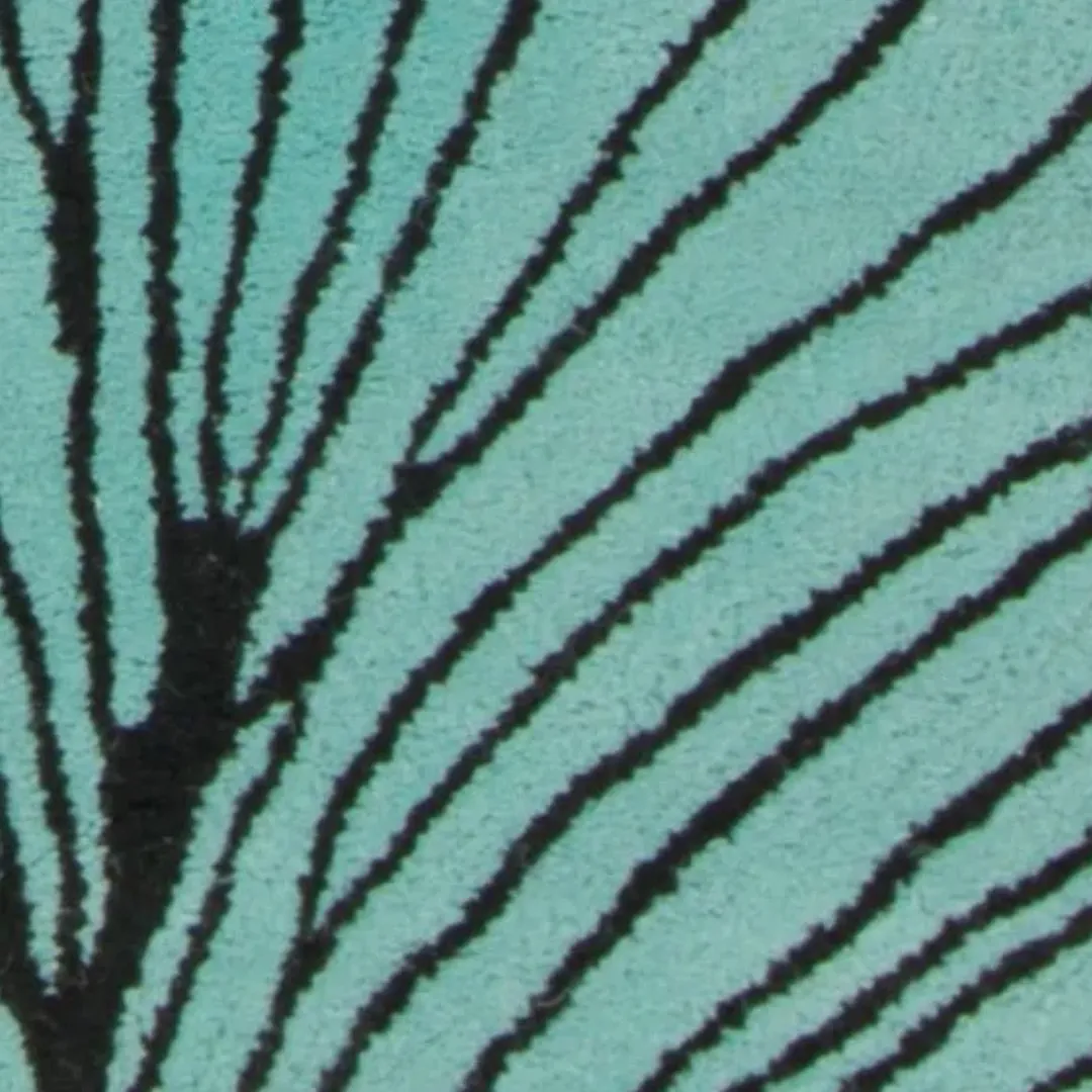 Close-up of teal and black linework on ginkgo leaf rug
