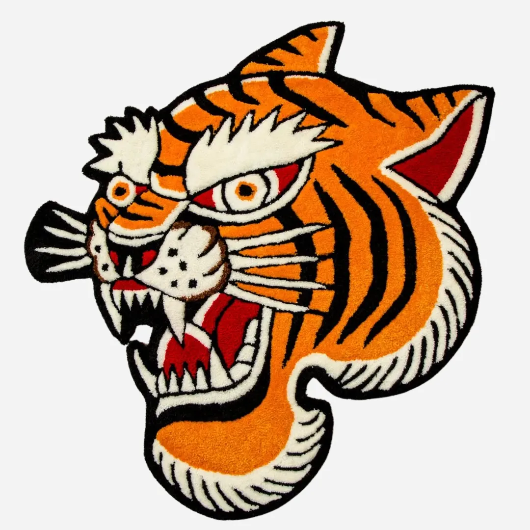 Bold tiger head rug in traditional tattoo style with orange, black, and red details, custom cut and tufted for statement interiors.