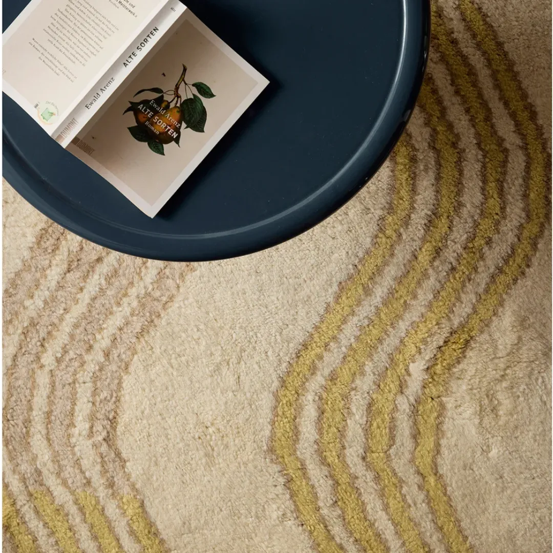 Wavy mustard stripes rug styled in a cozy modern living room