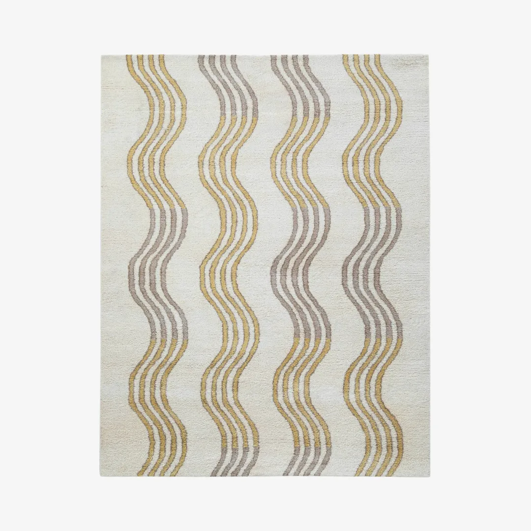 Wavy mustard and taupe striped area rug on cream background