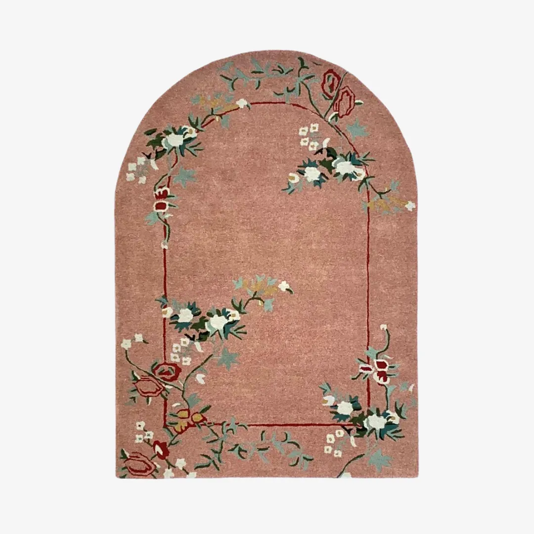 Floral hand-tufted rug with arched design in pink, red, and green
