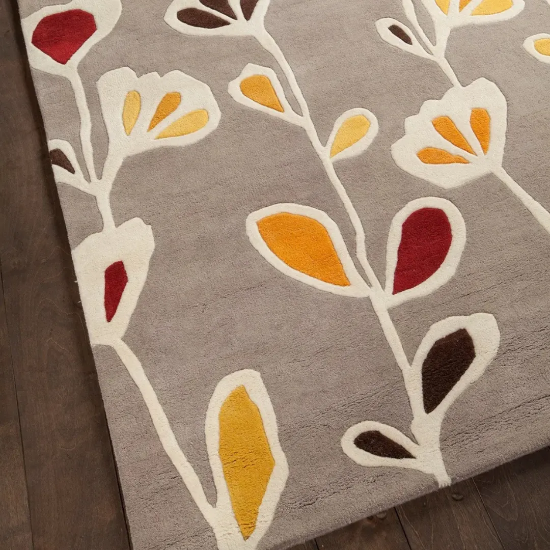 Floral hand-tufted rug in red, yellow, and orange