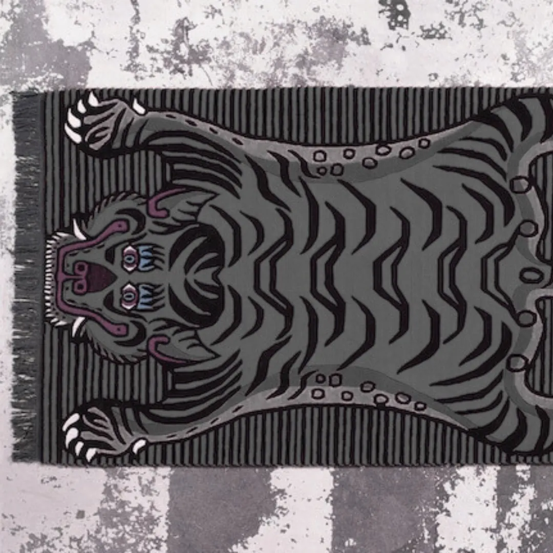 Black and grey tiger rug with striped pattern and fierce stylized tiger face.