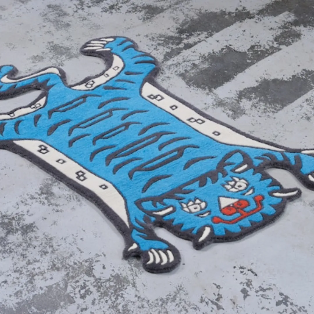 Blue tiger rug with bold black stripes and artistic face design