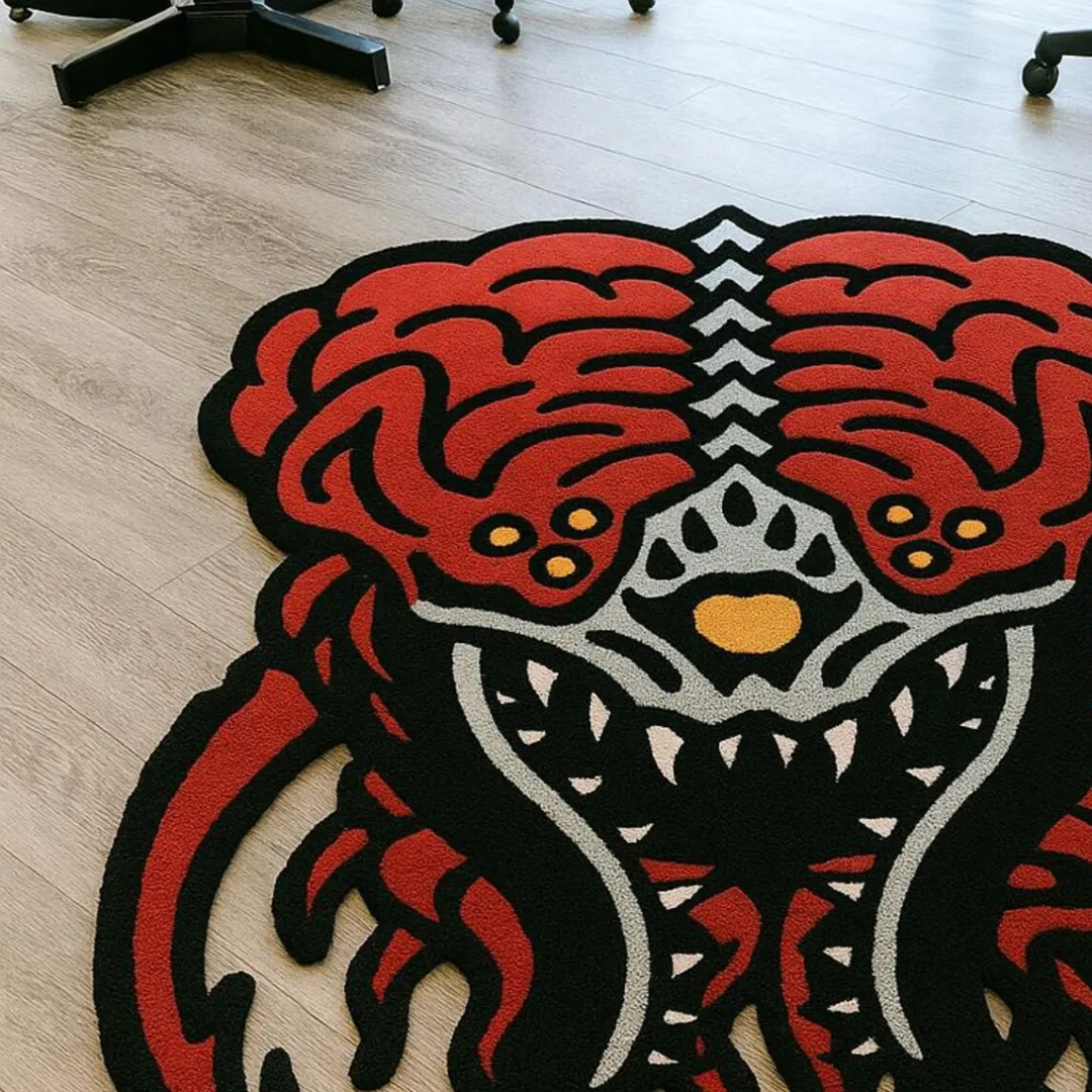Red and black wool rug with fierce tattoo demon face