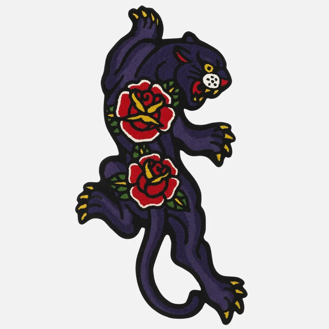 Tattoo-style black panther rug with red and yellow roses on a white background