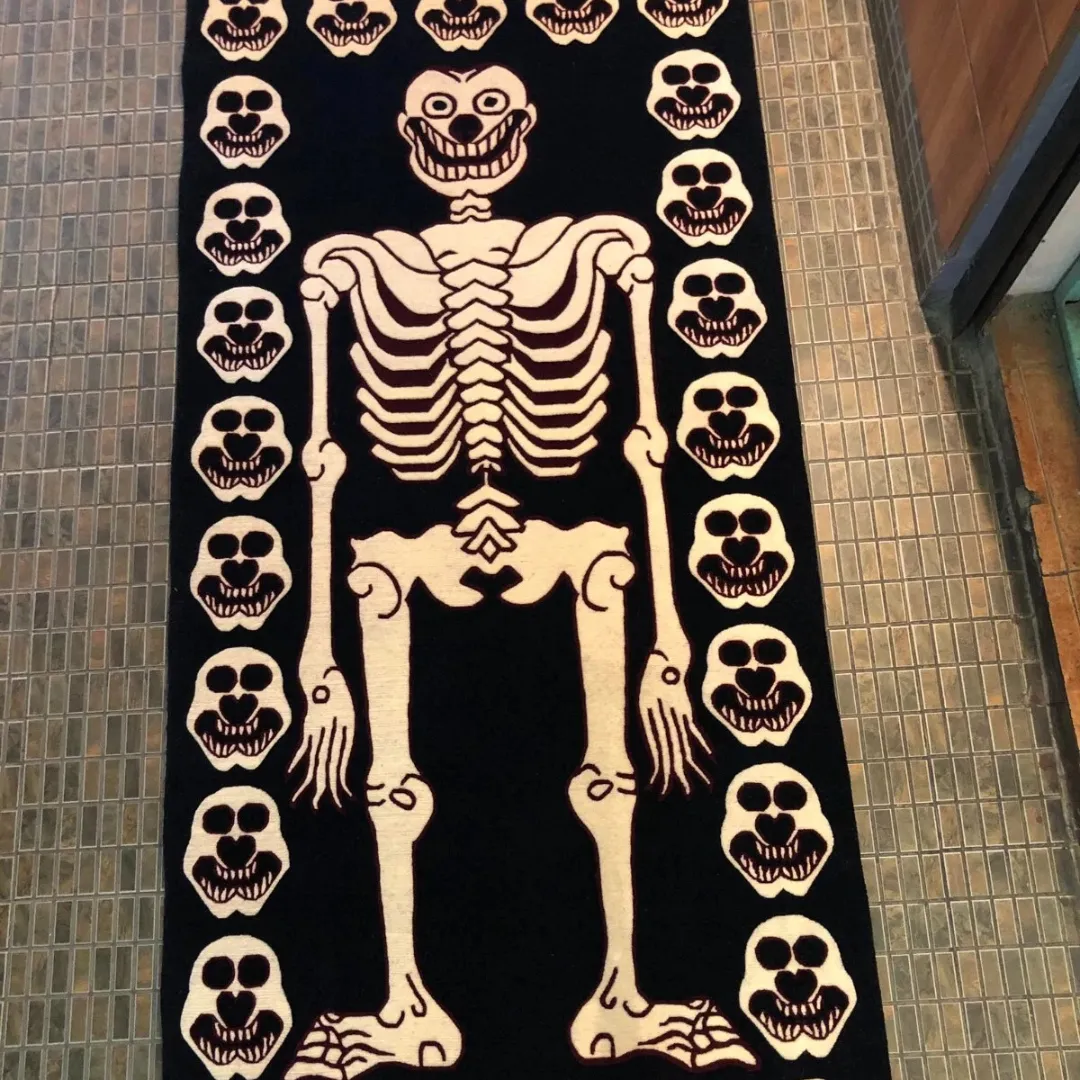 Skeleton rug with mischievous skull and creepy faces on black background