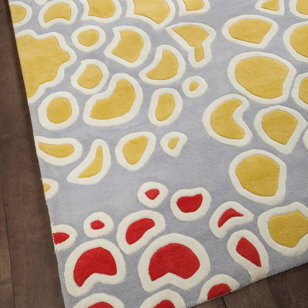 Bold red and yellow flowers on a soft blue wool rug