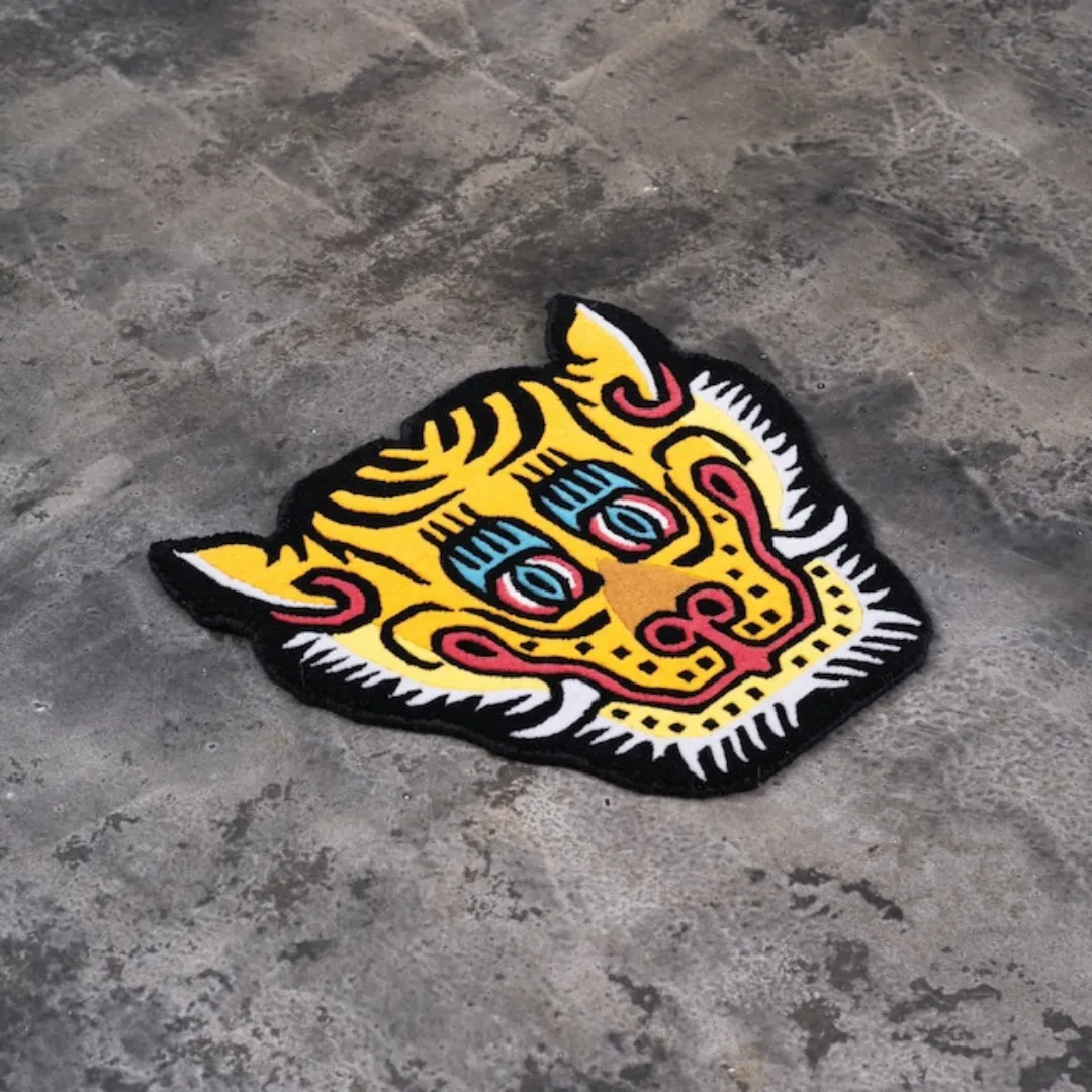 Decorative tiger face wall rug with blue eyes and curved patterns, handcrafted from 100% wool.