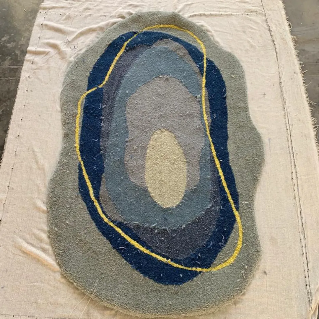 Auralis rug with smooth flowing organic design in shades of blue and yellow.