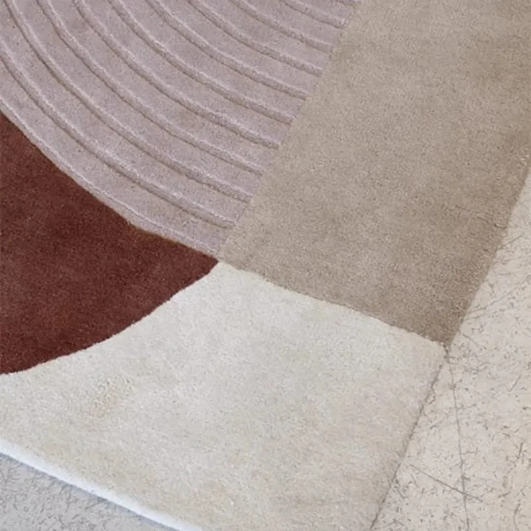 Geometric design rug in blush pink and terracotta, perfect for modern spaces.