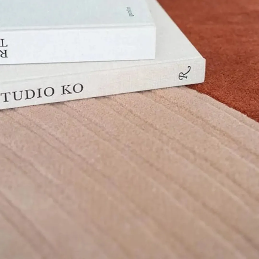 Abstract design rug in blush pink and terracotta, perfect for modern spaces.