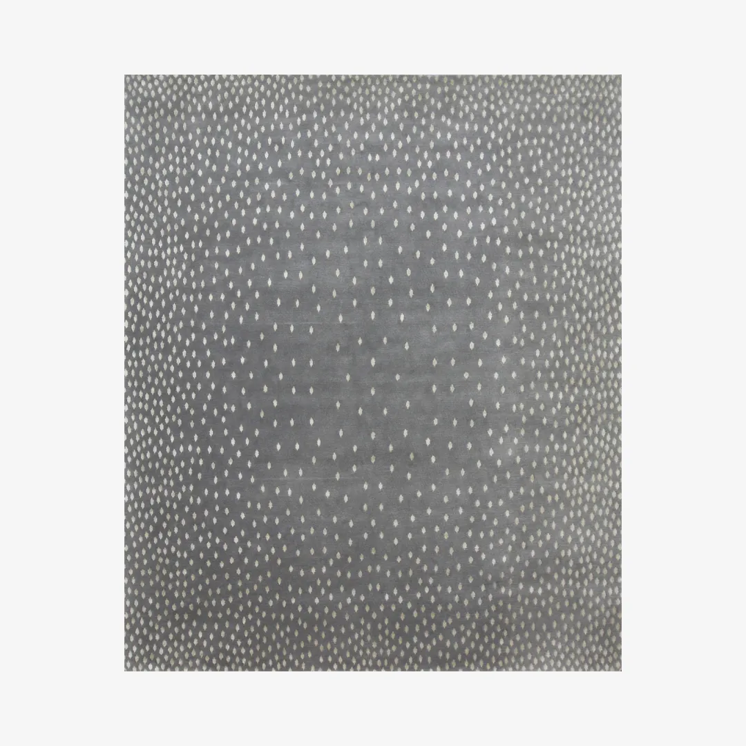 Gray area rug with white dotted pattern.