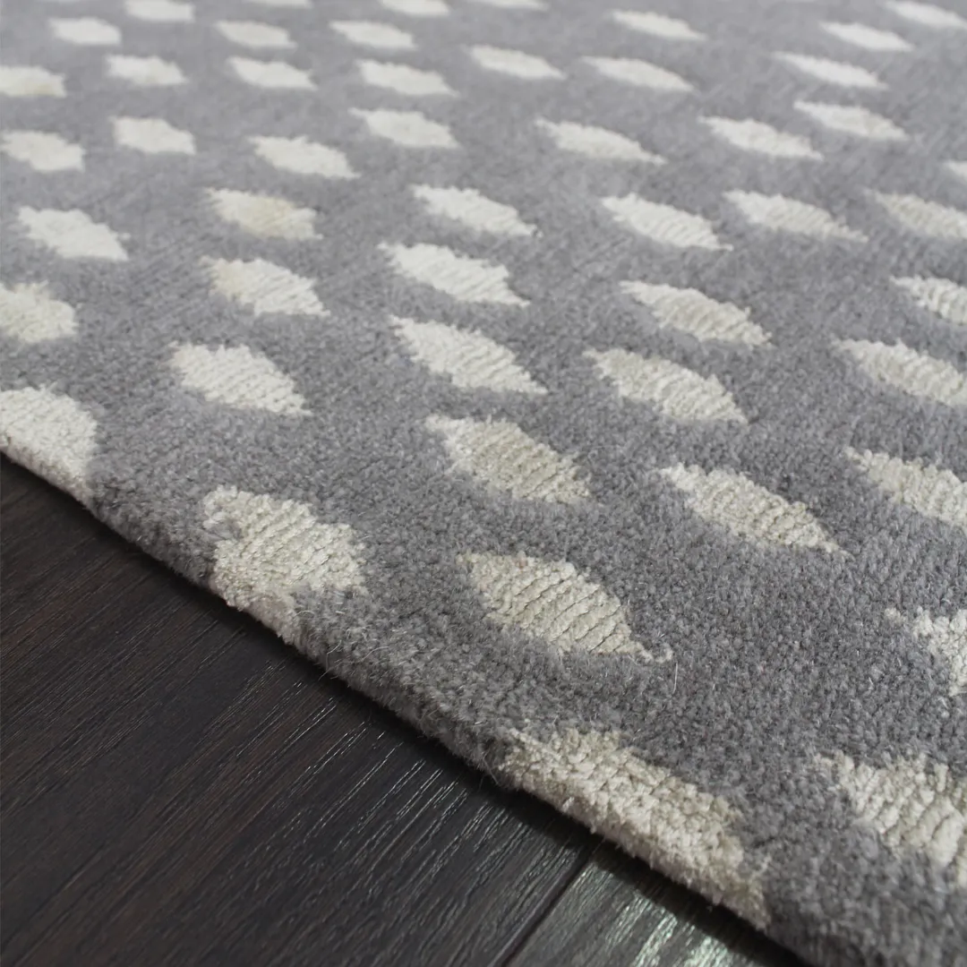 Modern gray rug with delicate white dots across it.