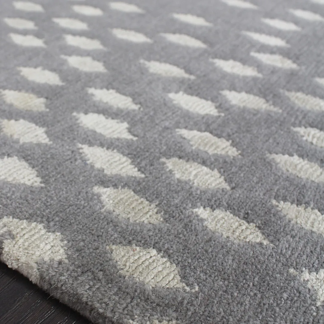 Subtle dot design rug in gray with white accents.