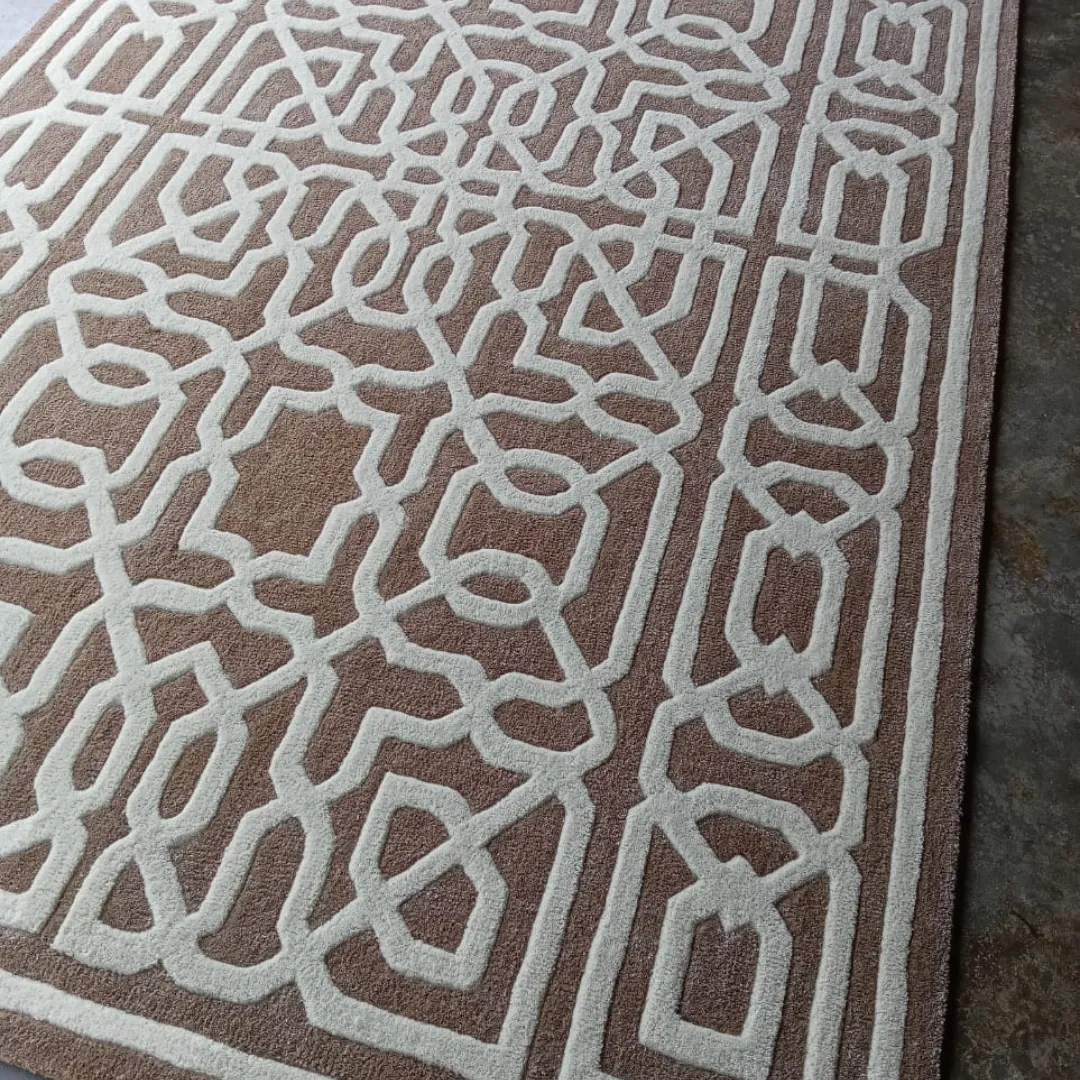Modern geometric rug with symmetrical design and soft beige hues.