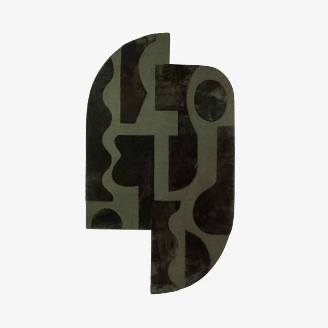 Abstract face-shaped design rug in dark green tones.